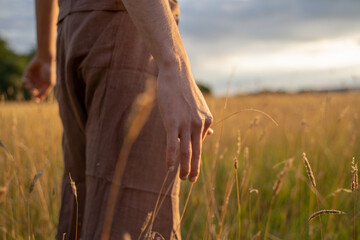 Midsection of man standing amidst plants on landscape against sky in forest