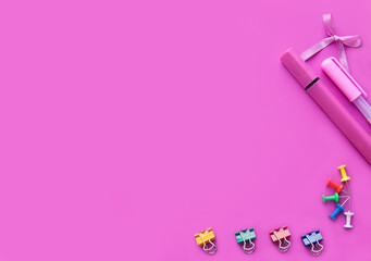 Set of office supplies on a pink background, top view