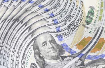 one hundred dollar bills swirl