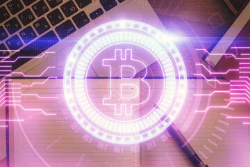 Obraz premium Blockchain theme hologram drawings over computer on the desktop background. Top view. Double exposure.