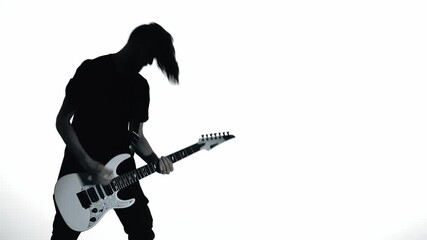 Silhouette of guitarist playing electric guitar - Powered by Adobe