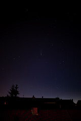 Comet C/2020 F3 Neowise right above silhouettes of city house roofs