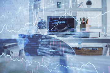 Double exposure of financial graph drawing and office interior background. Concept of stock market.