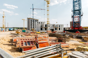 construction crane on the background of a new residential area and cloudy beautiful sky