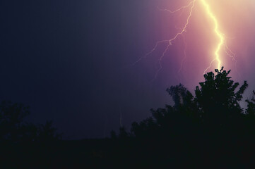 Fototapeta na wymiar Thunderbolt in the night. Thunder Strike lightnings during a raging storm in a wild nature