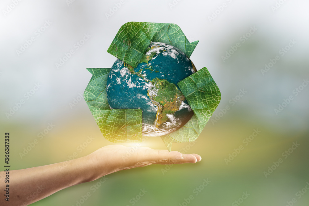 Canvas Prints hand holding planet earth and recycle icon over blur green background. elements of this image are fu