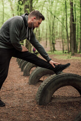 Obraz premium Adult sporty man in forest, park running in the morning