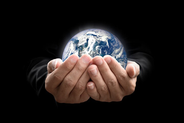 Environment concept. Earth in hands on black background. Elements of this image furnished by NASA