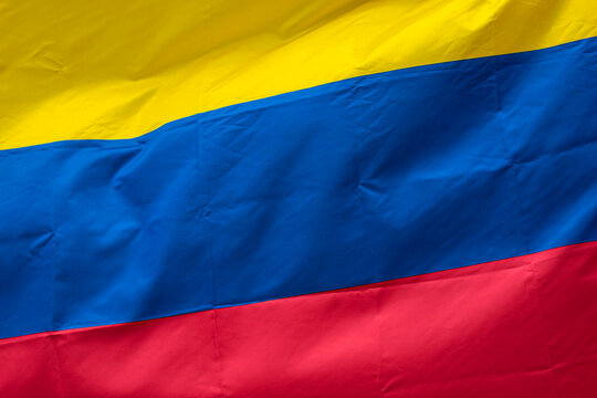 Closeup to a Colombian flag waving with the wind. Nationality and country concept