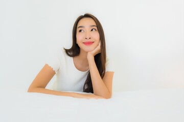 Portrait beautiful young asian woman relax happy smile on bed with white pillow blanket