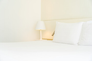 White comfortable pillow and blanket with light lamp