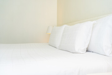 Fototapeta na wymiar White comfortable pillow and blanket with light lamp
