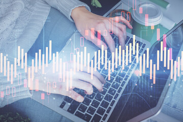 Double exposure of woman hands typing on computer and forex chart hologram drawing. Stock market invest concept.