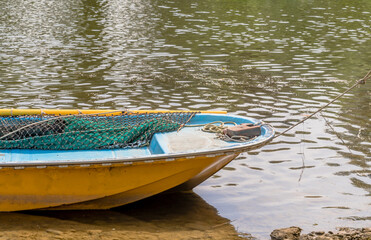 Bow of small yellow fishing boat