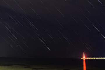 A view of the stars of the Milky Way with a mountain top in the foreground. Night sky nature summer...