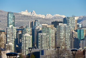 Vancouver Winter Skyline Towers. Office towers of Vancouver against the peaks of the Coast Mountains on a sunny, postcard morning.

