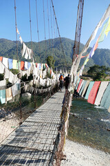 Prayer flags  protect suspension bridge