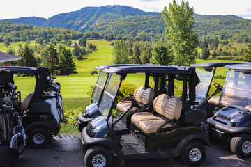 golf cart parked in front of a golf court in summer © Veronique