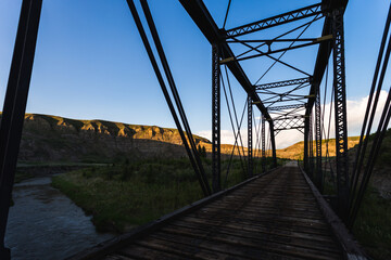 view of inside a metal bridge in summer on a sunset 