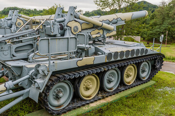 Side view of military tank  on display in public park near Nonsan, South Korea on an overcast day.