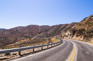 road in the desert with a super bright blue sky