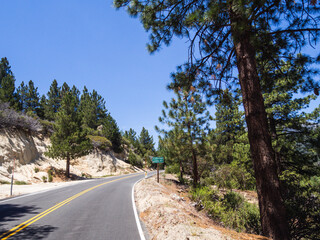 elevated road in the mountains with a super bright blue sky