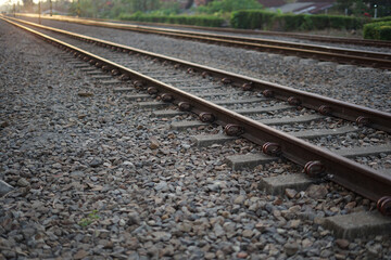 Fototapeta premium Close up and selective focus photo of railway track or railroad with morning sunlight.