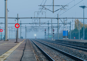 Train emerging from fog bank
