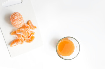 Orange juice in a glass with oranges peeled for copy space text