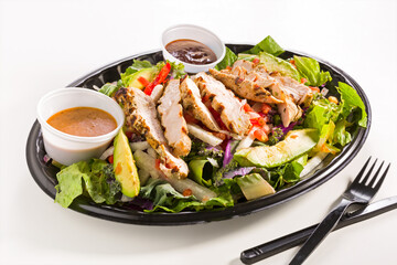 Barbecue chicken salad in a carry out container