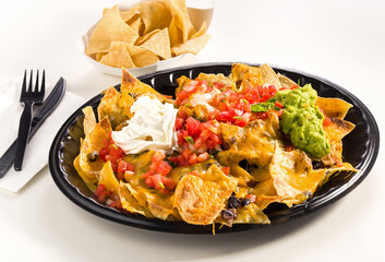 Nachos platter with tortilla chips in a carry out container