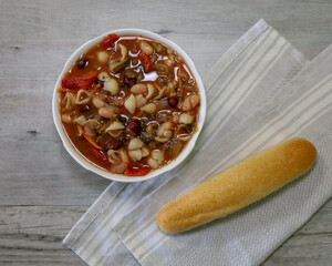 Top view of a white bowl of Minestrone Soup with Pasta, Beans and Vegetables