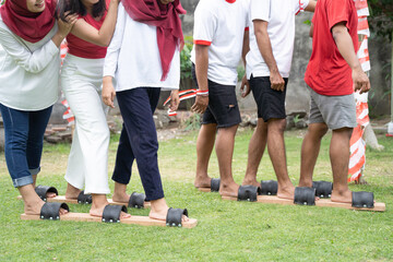 Fototapeta premium image of many legs participating in the bakiak race during the 17 August celebration of Indonesia's independence day