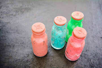Whole and cracked glass bottles with rubber corks and dried old artistic paint