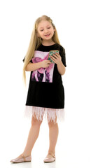 The girl is using a cell phone.The concept of people and technology.