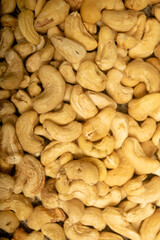 Cashew nuts scattered surface texture. Close up.