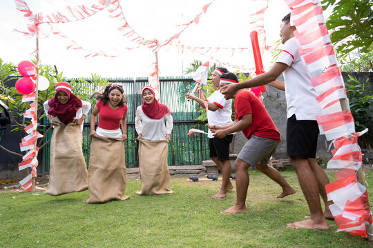 Indonesian girls took part in a sack race supported by spectators on the field