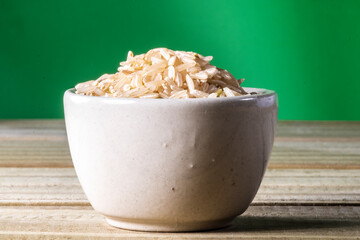 integral rice on glass bowl isolated on wooden table in Brazil