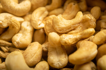 Cashew nuts scattered surface texture. Close up.