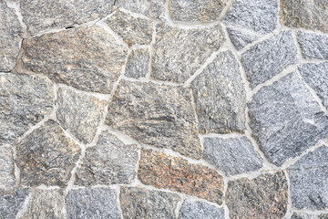 Close up part of a stone wall rustic grunge seamless texture background