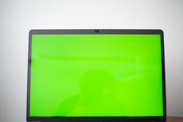 Close up laptop with green screen.