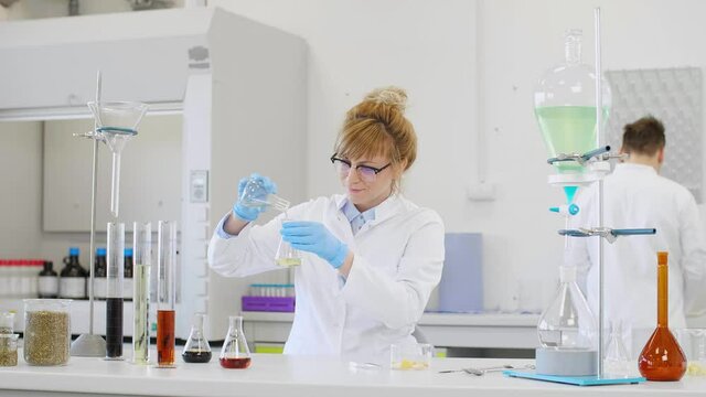 Chemist working with hemp CBD oil in laboratory