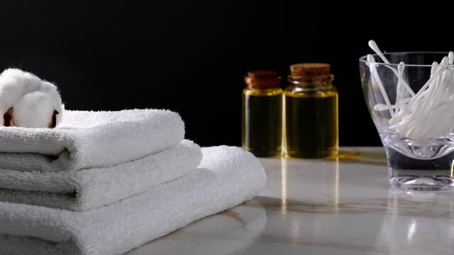 Throwing of cotton swabs into glass and putting of cotton flowers on towels
