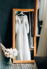 Modern wedding dress in the room with reflection in mirror