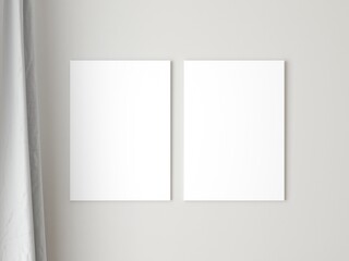 Two empty vertical canvas frame on grey wall. 3d illustration.