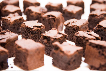 Chocolate brownies cut in small cubes on a plate ready to serve