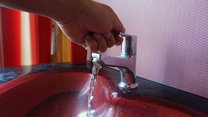 A Person washes his hand with water due to coronavirus.