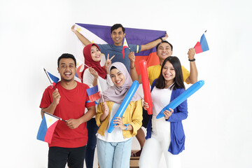 excited asian young supporter holding philippines flag over white background