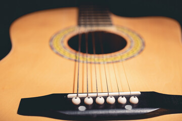brown acoustic guitar on sofa