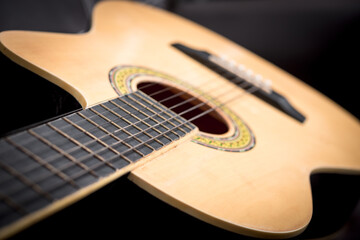 Fototapeta premium brown acoustic guitar on sofa
